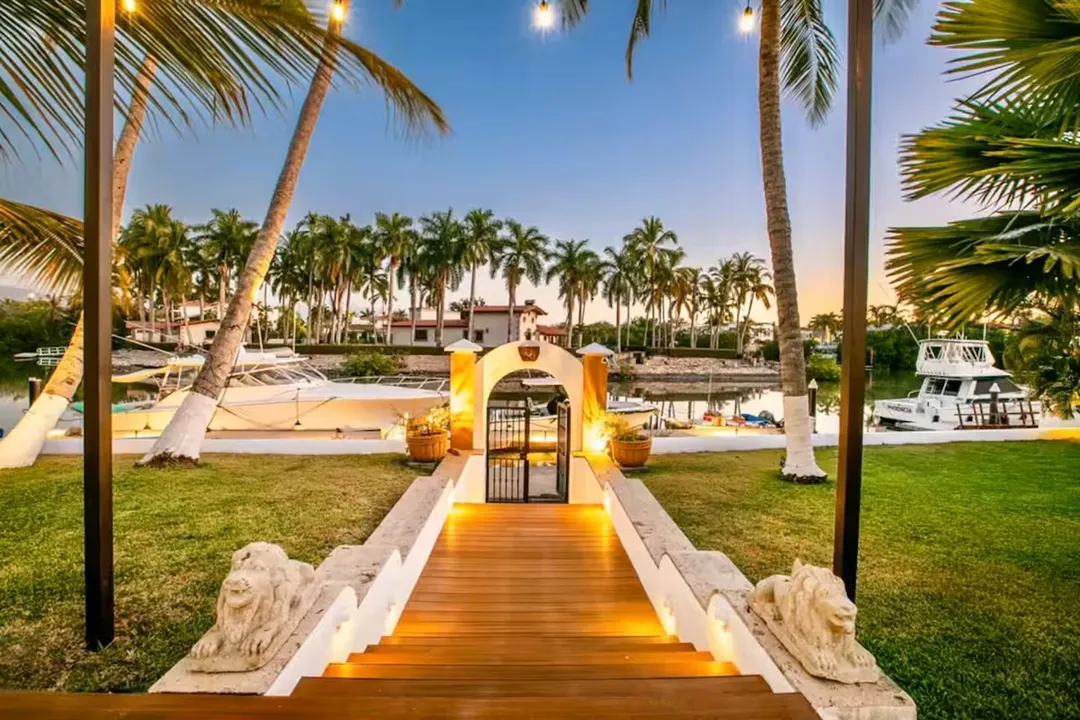 Lit walkway to the private marina at dusk