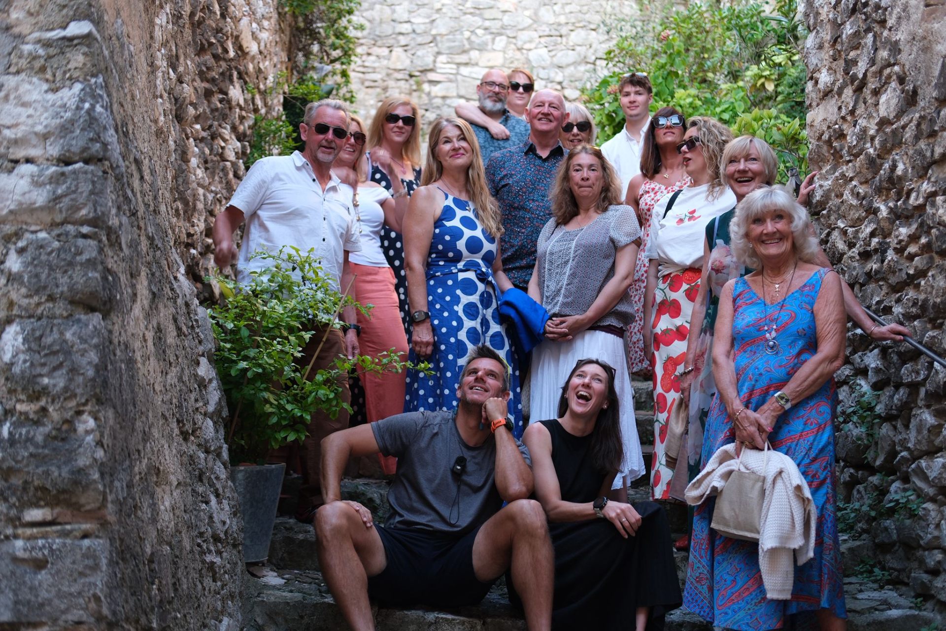 Guests laughing on ancient village steps