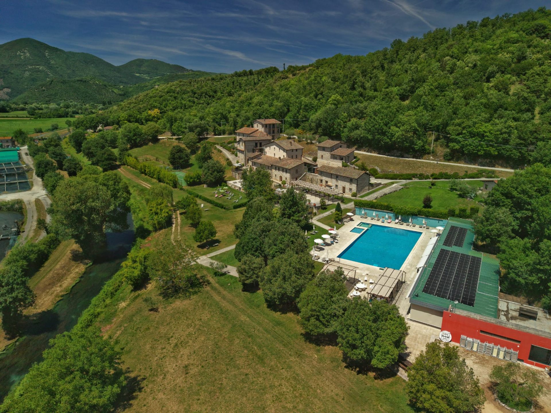 Aerial view of Relais Villa d'Assio nestled in the Umbrian hills