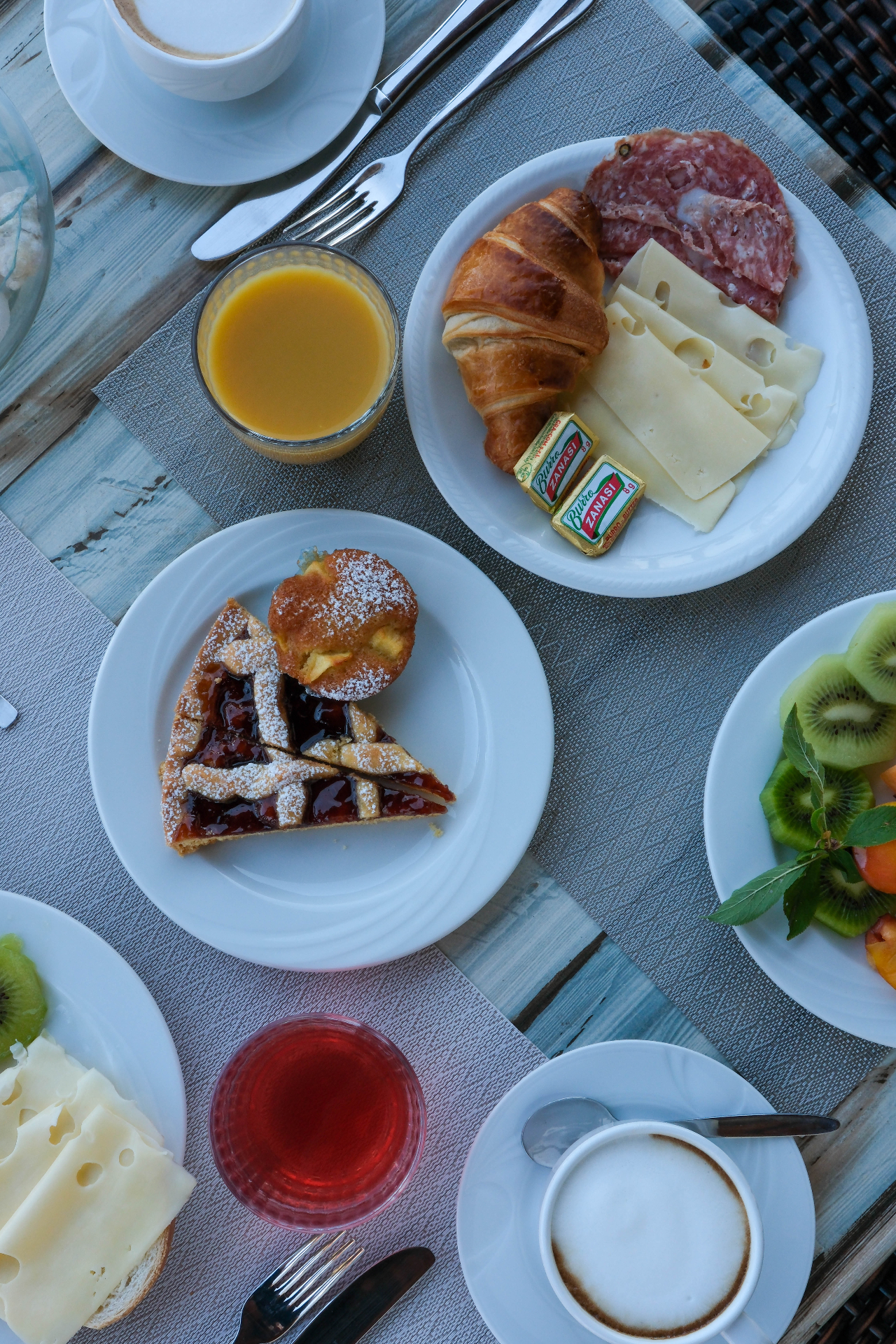 Slow Italian breakfast — croissants, cheeses, jam tart and cappuccino