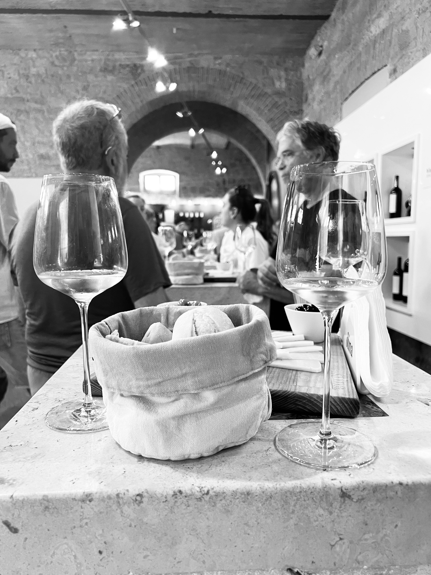 Wine and fresh bread in a stone-vaulted cellar tasting room