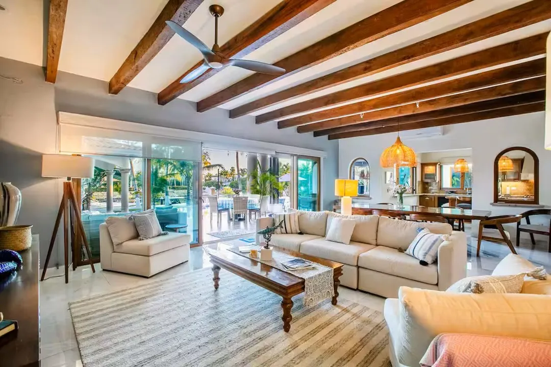 Open-plan living room with beamed ceilings